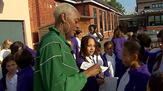 Athlete Perri Shakes-Drayton is standing in a primary school playground in London handing out stickers to children who have taken part in the Daily Mile.