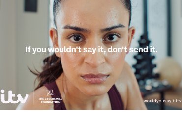 A young woman is making eye contact with the viewer. She looks perplexed. 'If you wouldn't say it, don't send it' is written over the centre of the image. ' hashtag WouldYouSayIt' bottom right. ITV and The Cybersmile Foundation logos bottom left. 